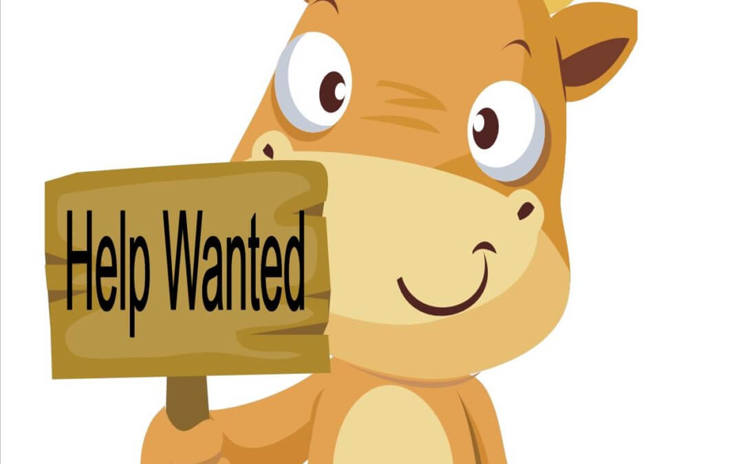 Cow holding Help Wanted sign